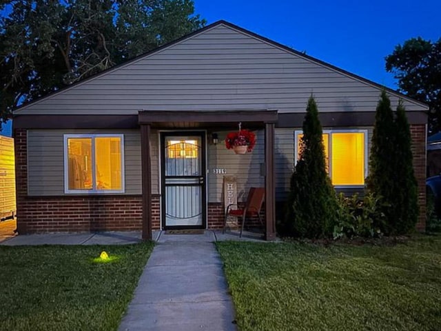 bungalow-style home featuring a front yard