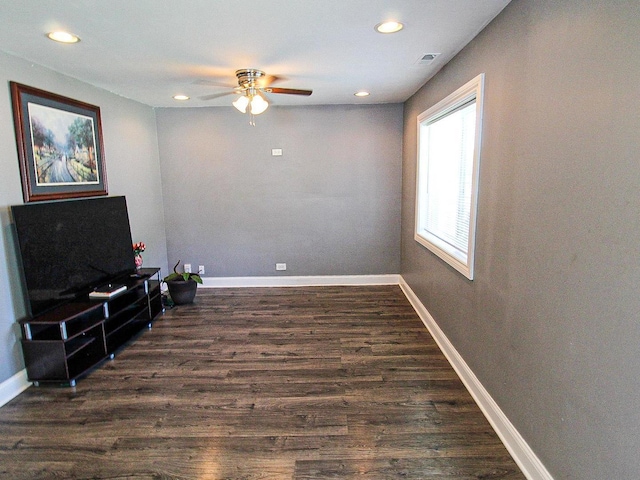 living area with ceiling fan and dark wood-type flooring