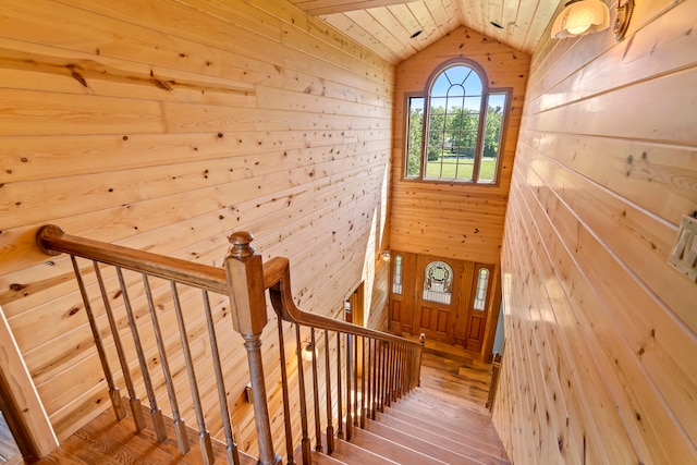 stairs featuring vaulted ceiling, hardwood / wood-style floors, and wood ceiling