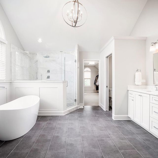 bathroom with vanity, lofted ceiling, an inviting chandelier, tile patterned floors, and separate shower and tub