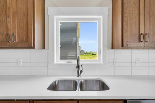 kitchen featuring tasteful backsplash and sink