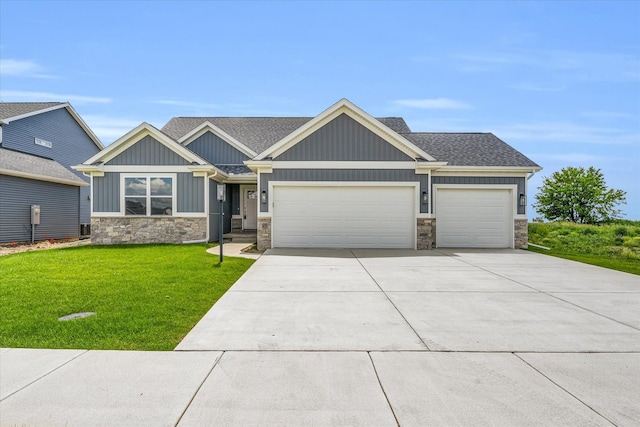 craftsman inspired home featuring a garage and a front lawn