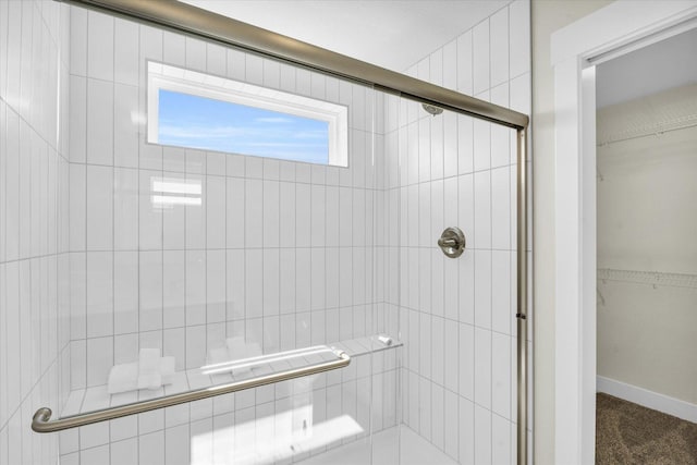 bathroom with a shower with door