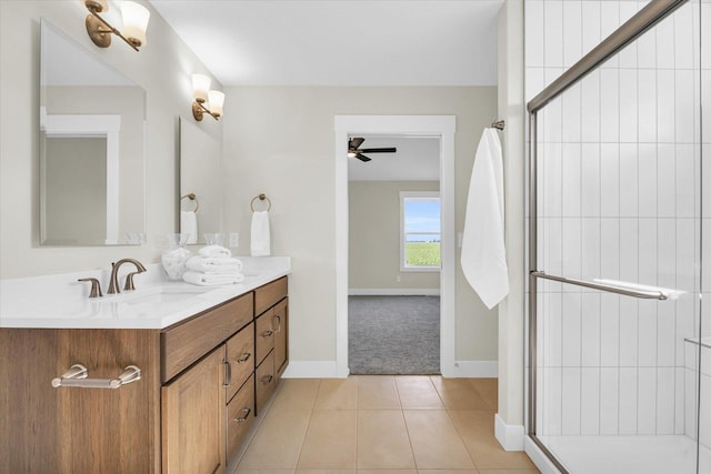 bathroom featuring tile patterned flooring, vanity, a shower with door, and ceiling fan