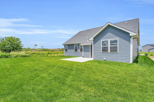 back of property with a yard and a patio area