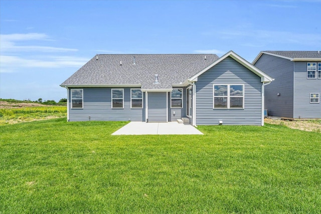 back of house with a yard and a patio