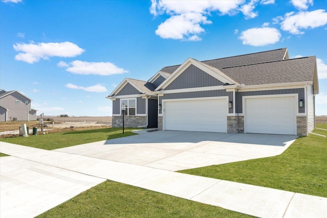 craftsman-style home featuring a front yard and a garage