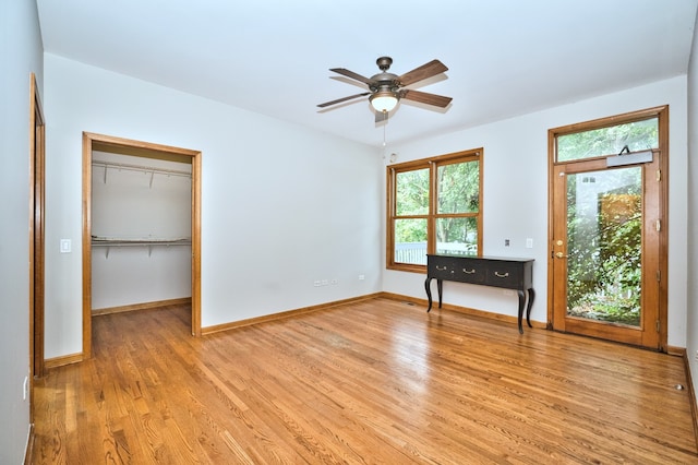 unfurnished bedroom featuring a closet, light hardwood / wood-style floors, and ceiling fan