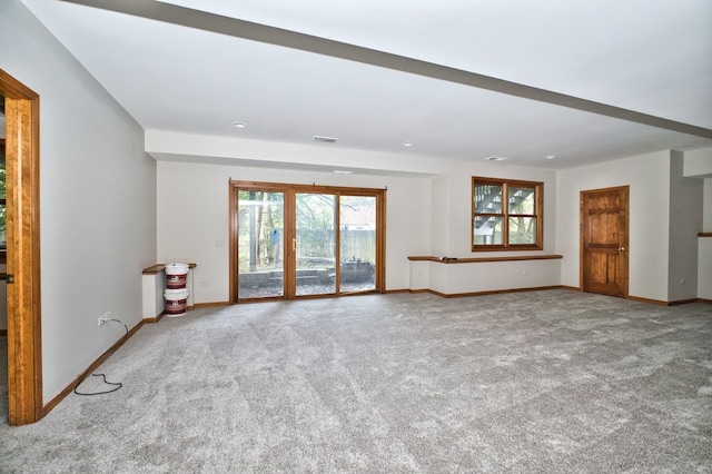 unfurnished living room featuring light carpet