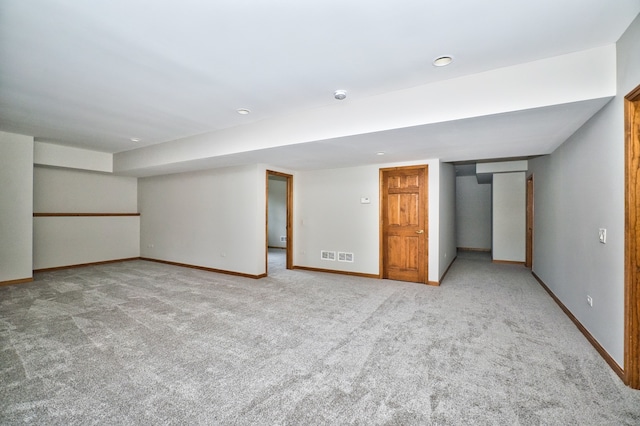 basement featuring light carpet