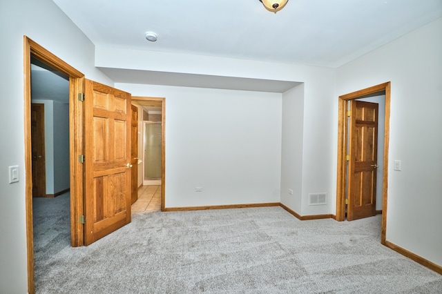 unfurnished bedroom featuring light colored carpet