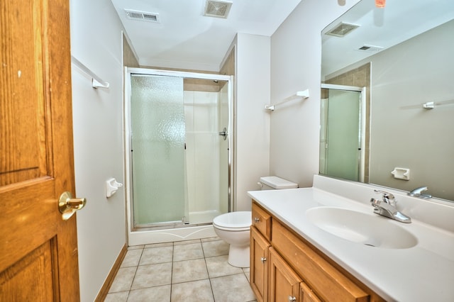 bathroom with vanity, tile patterned flooring, a shower with shower door, and toilet