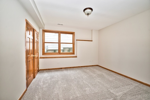 empty room with light colored carpet