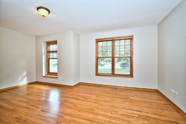 empty room with light hardwood / wood-style floors