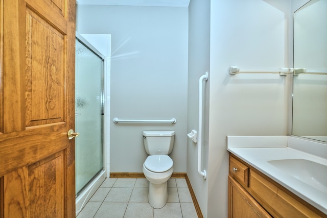 bathroom featuring tile patterned flooring, a shower with door, toilet, and vanity