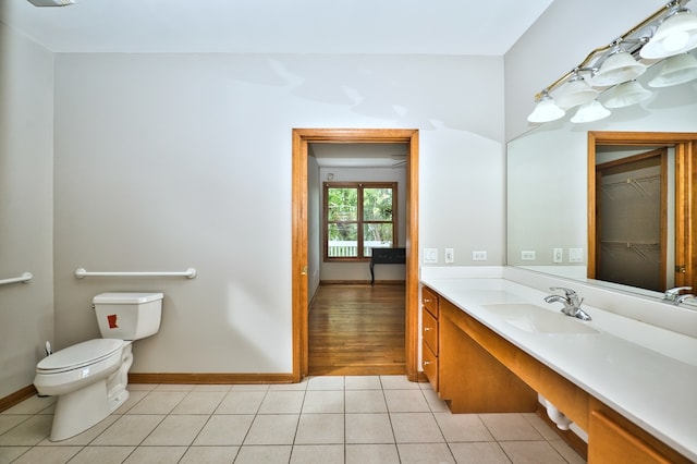 bathroom with wood-type flooring, vanity, and toilet