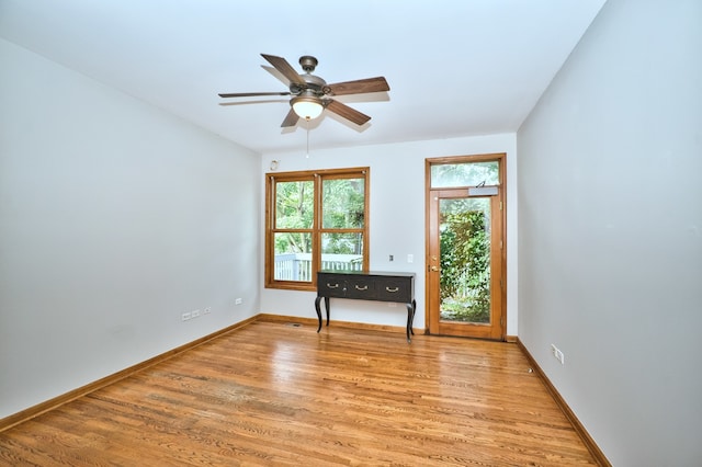 unfurnished room with light wood-type flooring and ceiling fan