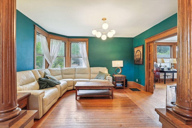 living room with hardwood / wood-style floors and a notable chandelier