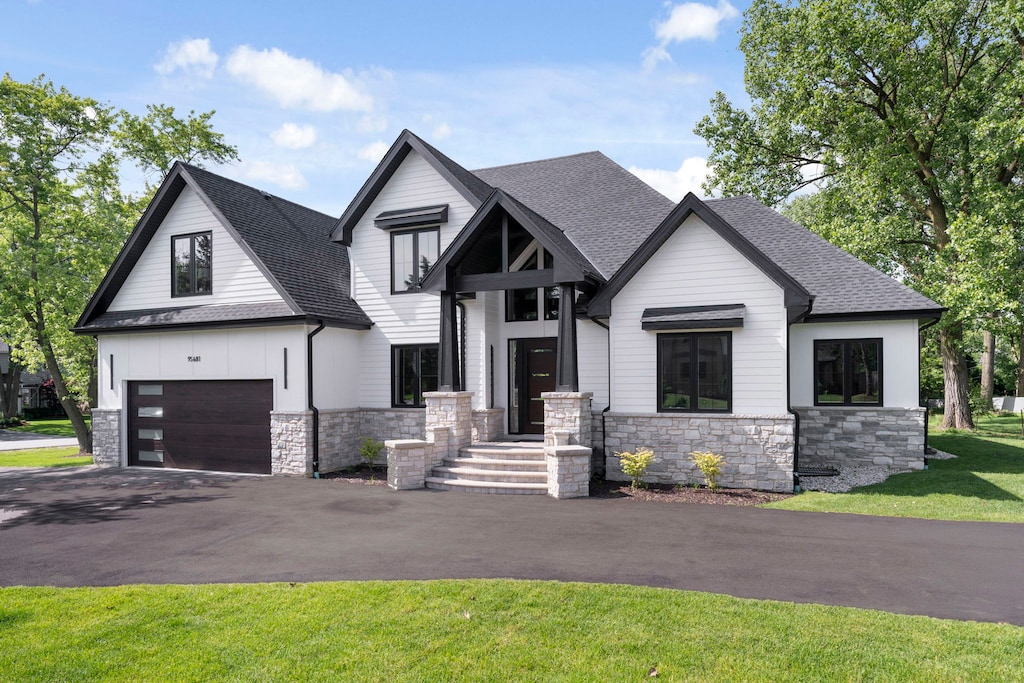 view of front of house with a front yard and a garage