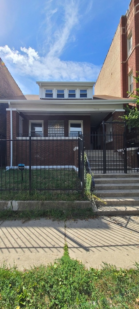 doorway to property with a lawn