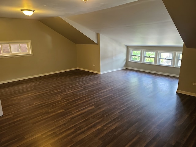 bonus room featuring dark hardwood / wood-style flooring and vaulted ceiling