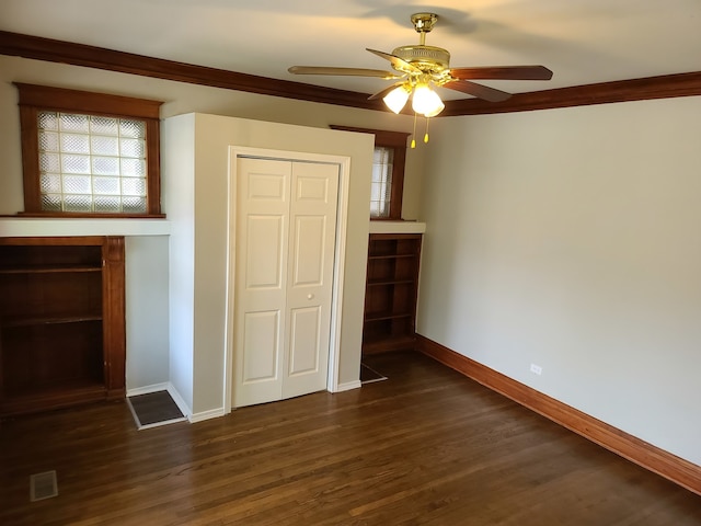 unfurnished living room with dark hardwood / wood-style flooring, ceiling fan, and crown molding