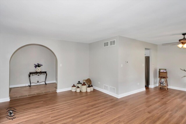 spare room with hardwood / wood-style flooring and ceiling fan