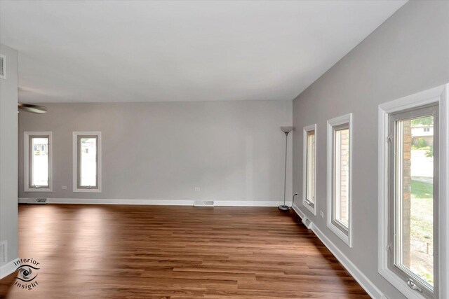 unfurnished room with wood-type flooring and plenty of natural light