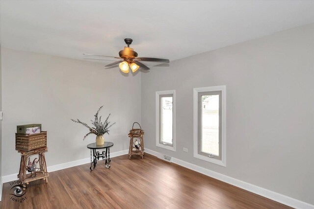 empty room with ceiling fan and wood-type flooring