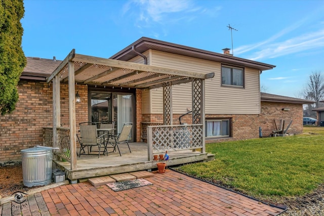 back of property featuring a wooden deck, a yard, and a pergola