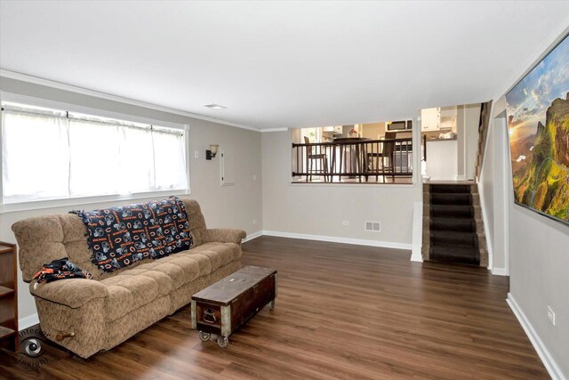 living room with ornamental molding and dark hardwood / wood-style flooring