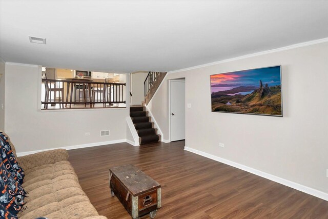 living room featuring ornamental molding and dark hardwood / wood-style flooring