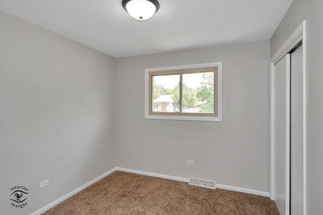 unfurnished bedroom featuring a closet and carpet floors