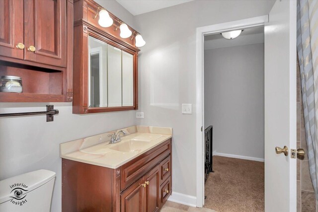 bathroom with toilet and vanity