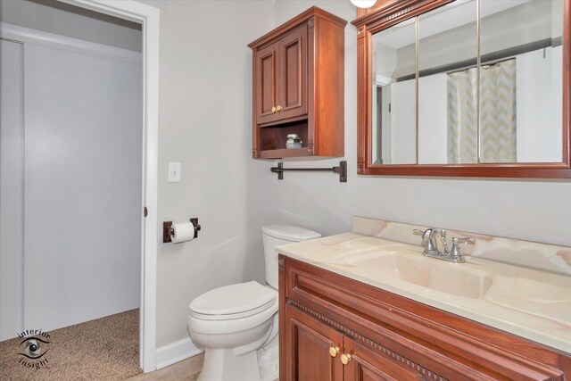 bathroom featuring vanity, toilet, and a shower with shower curtain