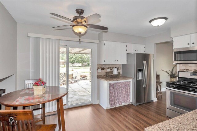 kitchen featuring ceiling fan, white cabinets, dark hardwood / wood-style floors, decorative backsplash, and stainless steel appliances