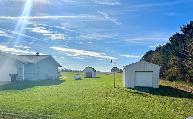 view of yard with a garage and a storage shed