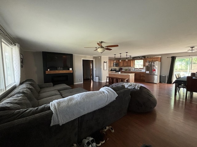 living room with wood-type flooring and ceiling fan