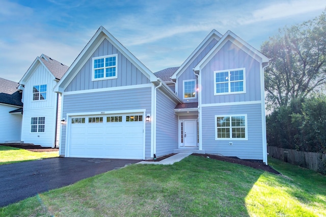 view of front of house with a garage and a front yard