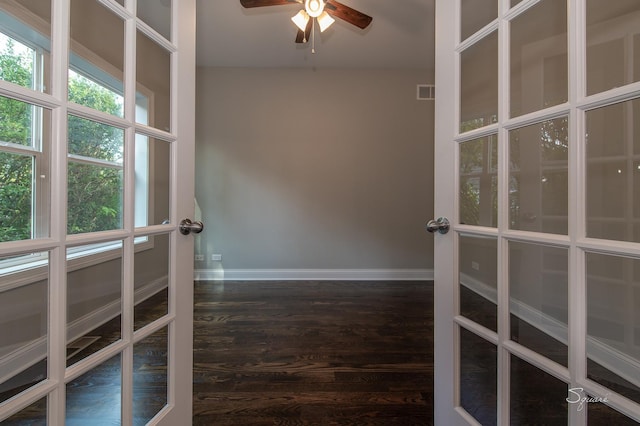 unfurnished room with dark hardwood / wood-style flooring, french doors, and ceiling fan