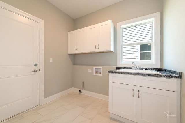 laundry area with cabinets, hookup for a washing machine, and sink