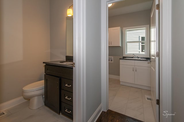 bathroom with vanity and toilet