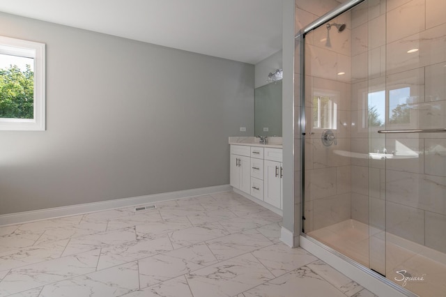 bathroom with walk in shower and vanity