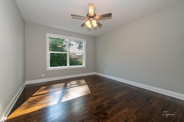 unfurnished room with dark wood-type flooring and ceiling fan