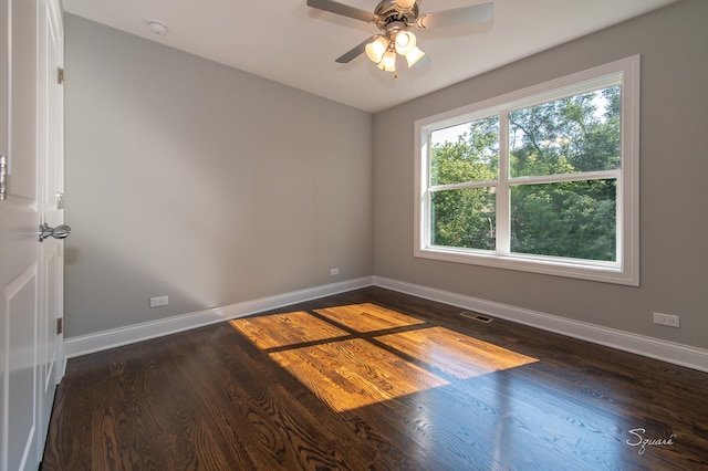 spare room featuring dark wood-type flooring and ceiling fan