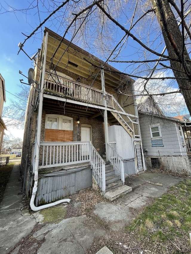 view of front of property with covered porch and a balcony