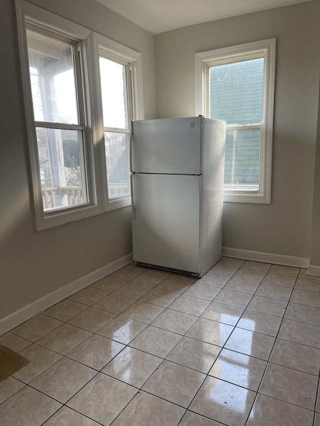 interior space featuring light tile patterned floors and a healthy amount of sunlight