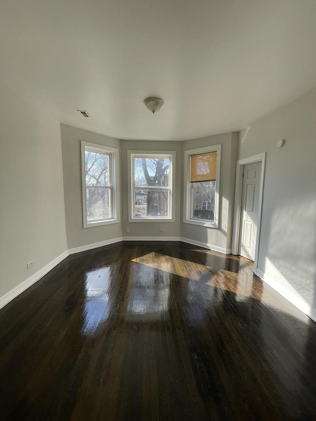 spare room featuring dark hardwood / wood-style flooring