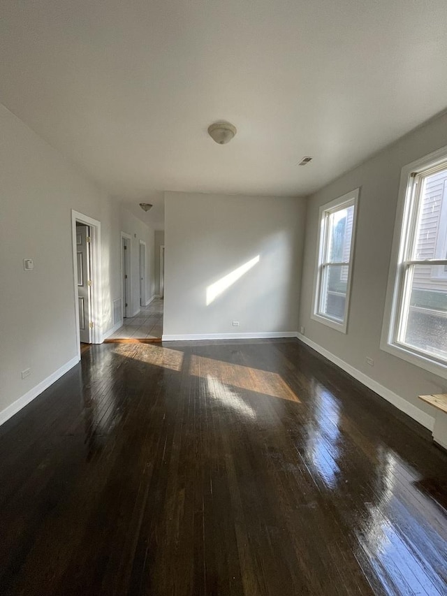 empty room featuring dark wood-type flooring