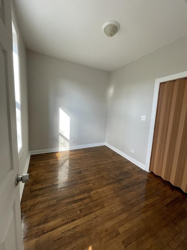 spare room with dark hardwood / wood-style floors